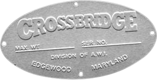 The metal nameplate is oval-shaped with a robust, industrial appearance. At the top, the company name "CROSSBRIDGE" is prominently embossed in raised letters, ensuring durability and clarity. Below this heading, there are designated blank spaces meant for inscribing essential details such as the maximum weight and serial number of the equipment—these allow for customization based on specific usage or inventory tracking. At the bottom edge of the nameplate, in smaller embossed lettering, it reads: "DIVISION OF A.W.A., EDGEWOOD, MARYLAND," signifying that CROSSBRIDGE operates as part of A.W.A. and giving both credibility and provenance to the equipment. Overall, this professionally crafted Crossbridge nameplate not only conveys key information but also enhances your machinery’s appearance with its high-quality finish and clear branding.